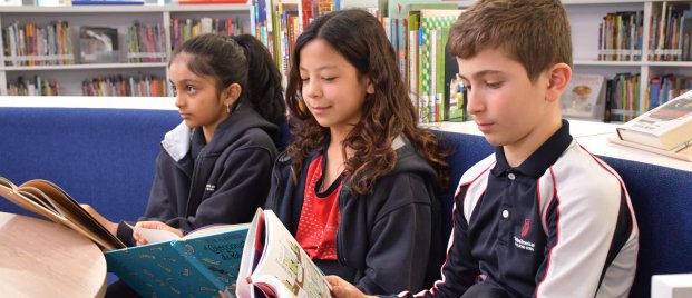 three students reading books