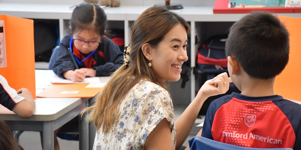 teacher helping student with school work