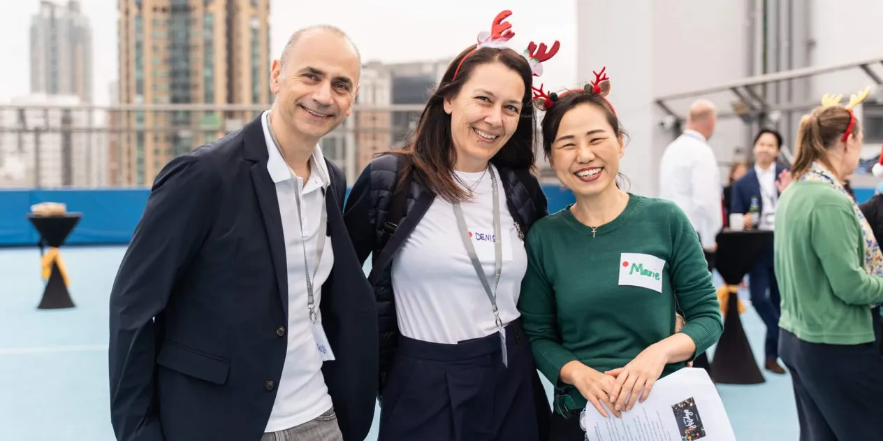 three staff members smiling
