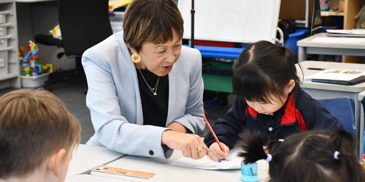 teacher helping kids with work