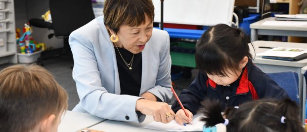 teacher helping kids with work