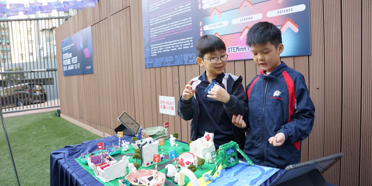 two young students showing their STEAM creation