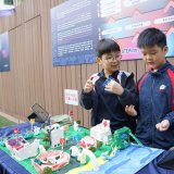 two young students showing their STEAM creation