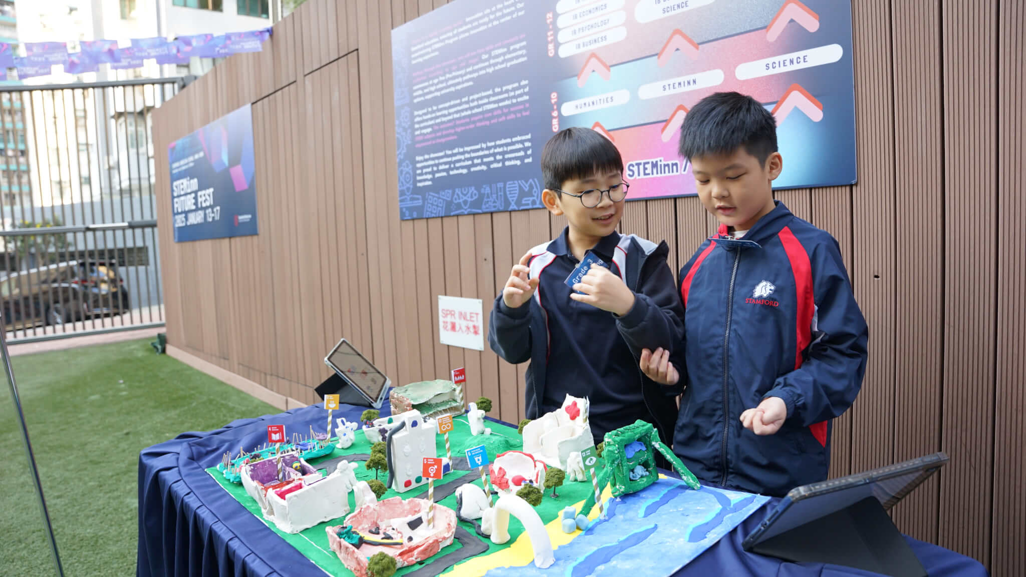 two young students showing their STEAM creation