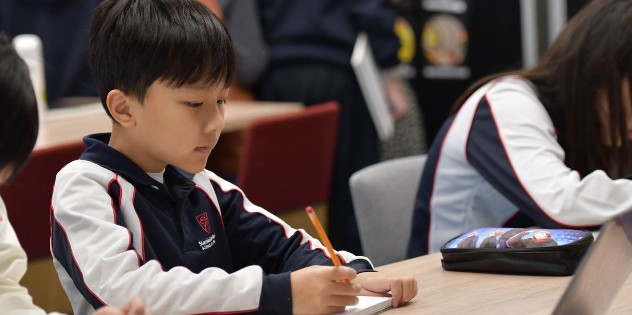 child working at his desk