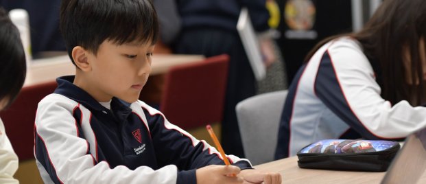 child working at his desk