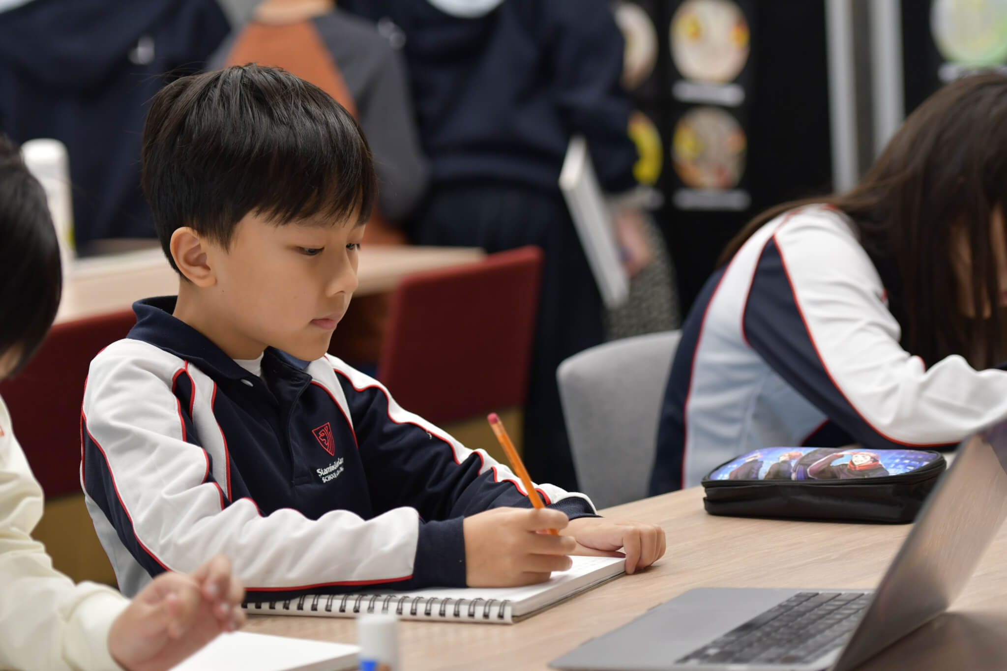 child working at his desk