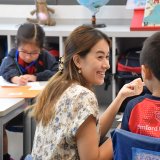 teacher helping student with school work