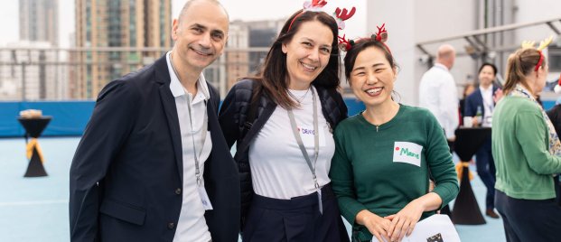 three staff members smiling