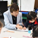 teacher helping kids with work