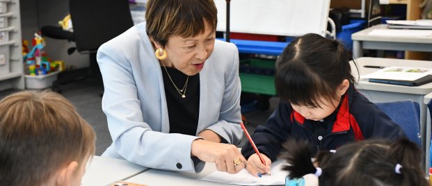 teacher helping kids with work