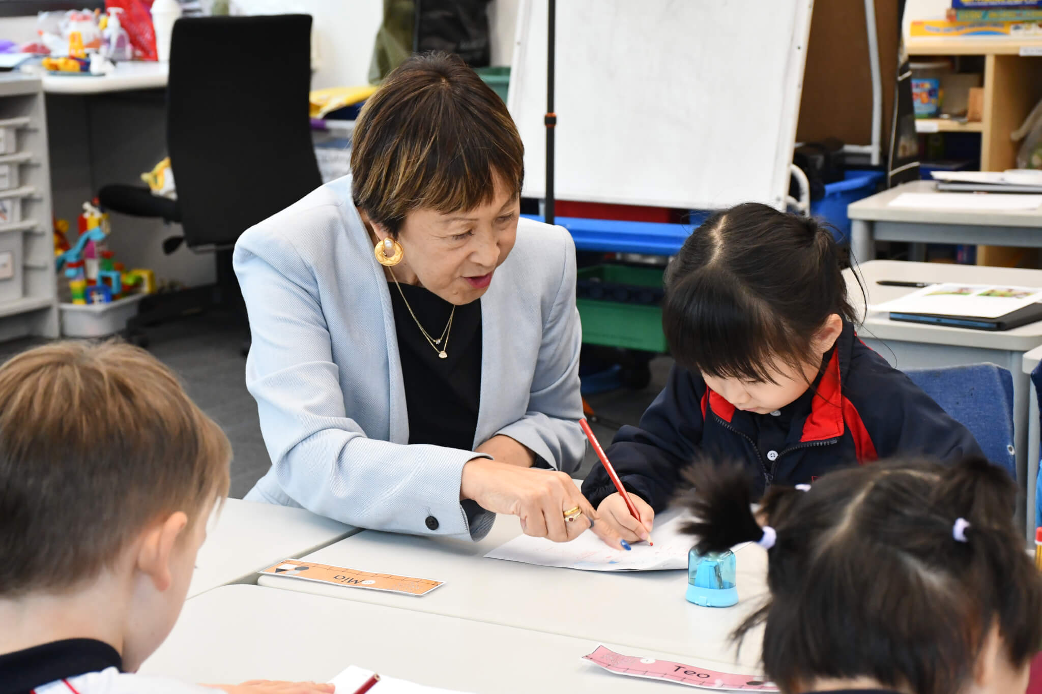 teacher helping kids with work